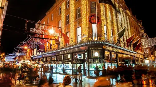Grafton Street on a busy Christmas Shopping Day at night