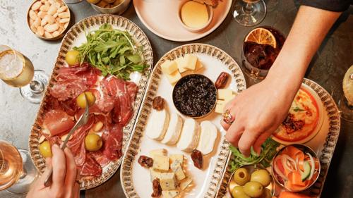 Food platter with hands reaching
