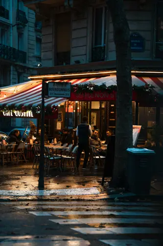 A waiter takes an order near the champs elysees in Paris